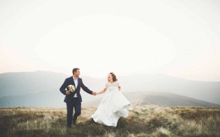 Wedding couple posing on sunset at wedding day. Bride and groom in love