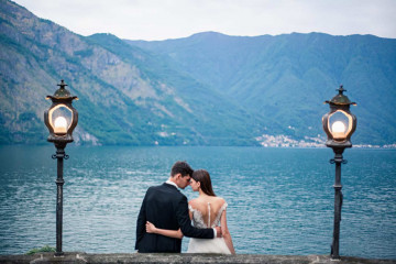wedding couple kissing on the background of a lake and mountains